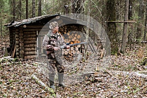 Hunter near a hunting lodge