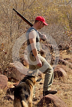 Hunter with rifle and dog