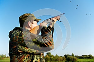 Hunter shooting with rifle gun