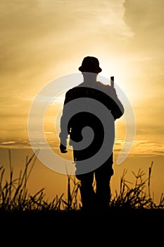 Hunter With Shotgun in Sunset