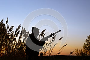 Hunter silhouette at sunset