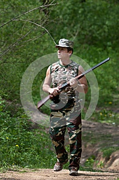 Hunter walking with rifle