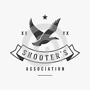 Hunters association with flying duck silhouette vector logo. Organization logotype well aimed shooters for extraction