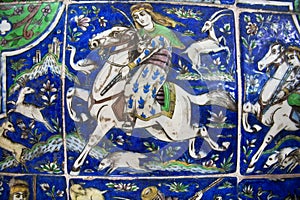 Hunters during the chase on the vintage ceramic tile, preserved since the 19th century