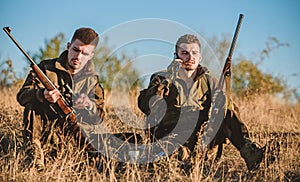 Hunters friends enjoy leisure. Rest for real men concept. Hunters with rifles relaxing in nature environment. Hunting