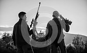 Hunters friends gamekeepers with guns silhouette sky background. Hunters rifles nature environment. That was great day