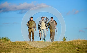 Hunters with guns walk sunny fall day. Brutal hobby. Guys gathered for hunting. Group men hunters or gamekeepers nature