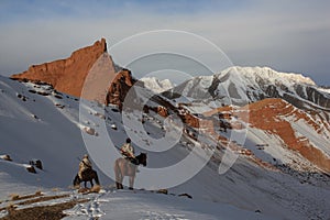 Hunters on horseback in winter in the mountains of Tien Shan