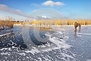 Hunters on the ice pond waiting victim.