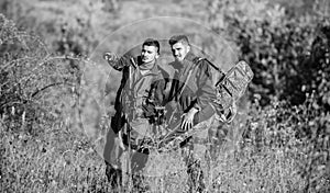 Hunters with rifles in nature environment. Poacher partner in crime. Activity for real men concept. Hunters gamekeepers