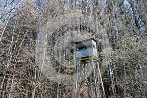 A hunters seat in the woods surrounded by trees in winter. Seen in a German forest