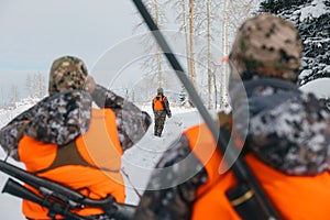 Hunters in a snowy landscape
