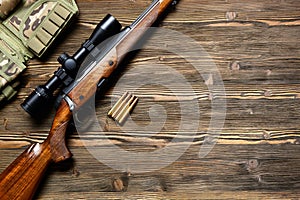 Hunting equipment on old wooden background.