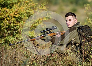 Hunting equipment for professionals. Hunting is brutal masculine hobby. Hunter hold rifle. Man wear camouflage clothes