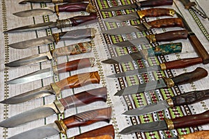 Hunting and fighting knives lying on the counter