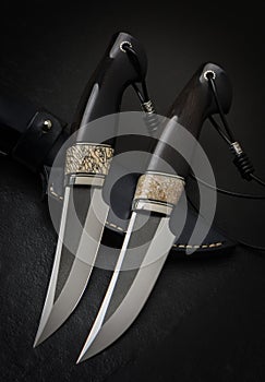 Hunting knife handmade on a black background