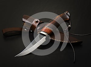 Hunting knife handmade on a black background