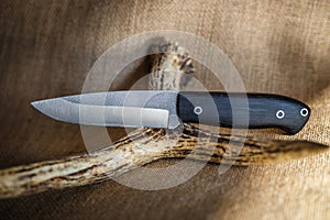 Hunting knife handmade on a brown background