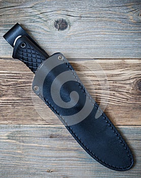 Hunting knife in a leather scabbard