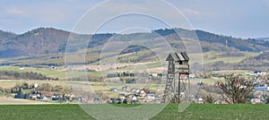 A hunting lodge for photographing and observing animals, the wooden structure is located near the forest. View of the Sudetes