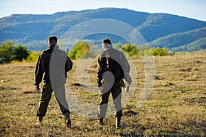 Hunting with partner provide greater measure safety often fun and rewarding. Hunters friends gamekeepers walk mountains