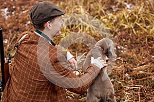 Hunting period, autumn season open. confident caucasian hunter with dog and gun