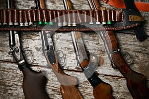 Hunting rifles with leather bandolier with ammunition