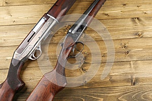 Hunting rifles on a wooden background