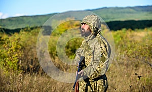 Hunting season. Man bearded hunter with rifle nature background. Experience and practice lends success hunting. How turn