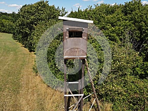 Hunting tower with a wooden ladder in the field