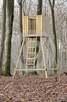 Hunting tower, wooden treehouse and observation structure in a forest or remote countryside woods. Timber wood lookout