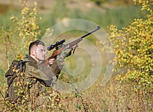 Hunting and trapping seasons. Bearded serious hunter spend leisure hunting. Hunter hold rifle. Man wear camouflage