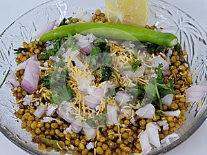 Hurda, Tender Jowar or Sorghum Bhel served in a bowl with green chilly and lemon. Selective focus