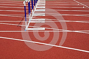 Hurdle bracket on red plastic runway