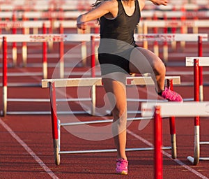 Hurdler tripping during a race on a track