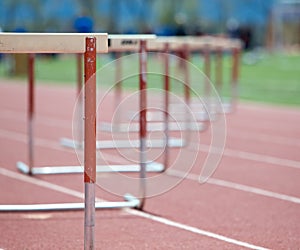 Hurdles lined up on a track, fading focus photo