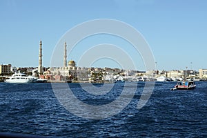 Hurghada sea side view with central muslim mosque and port of modern yachts and boats