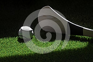 Hurling bat and sloitar on green grass. Horizontal sport theme poster, greeting cards, headers, website and app