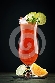 Hurricane, classic alcoholic cocktail with dark and white rum, ice, syrup, grenadine, pineapple and orange juice, lime and ice