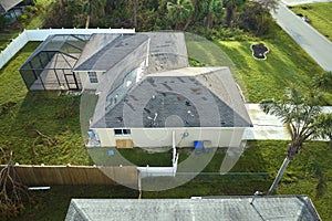 Hurricane Ian destroyed house roof in Florida residential area. Natural disaster and its consequences