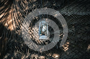 Hurricane lantern hangs outside the village cabana house