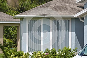 Hurricane shutters made from steel mounted for protection of house windows. Protective measures before natural disaster