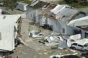 Hurricane strong wind destroyed suburban house roofs in Florida mobile home residential area. Consequences of natural