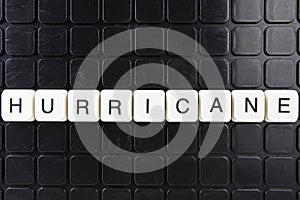 Hurricane text word title caption label cover backdrop background. Alphabet letter toy blocks on black reflective background.