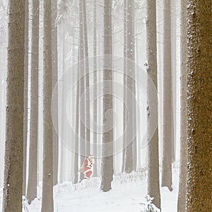 Hurried Santa Claus is running fast through the woods