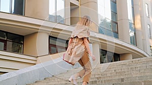 Hurried urban lifestyle stylish woman run up stair