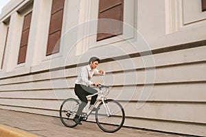 Hurry Asian businessman riding bike in rush hour. Young man lat