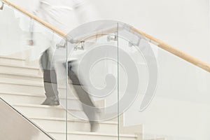 Hurry to save a life. Blur motion of doctor in white uniform hurrying and running upstairs photo