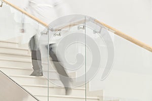 Hurry to save a life. Blur motion of doctor in white uniform hurrying and running upstairs