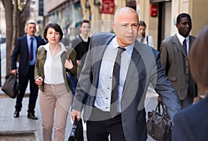 Hurrying businessman running on city street